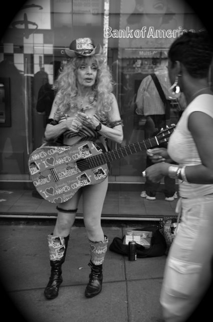 skimpy dressed old female guitar performer