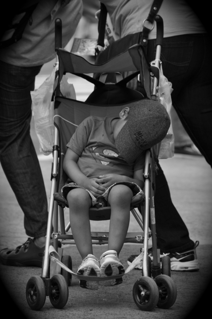 young boy sleeping in his stroller