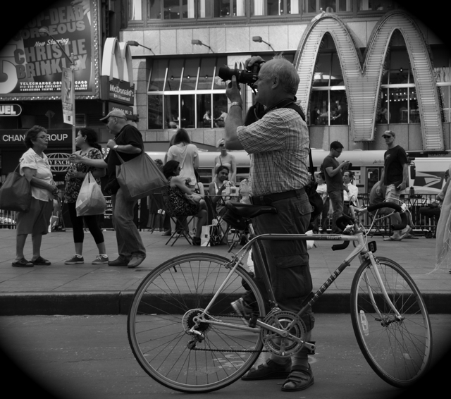 tourist with bike taking a picture