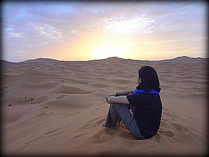 sunrise over the Sahara Desert: it's not obvious here, but I am sitting on top of a very tall sand dune.