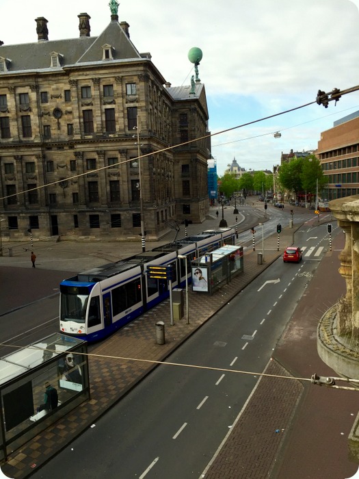 glimpse of the Royal Palace  and street behind Dam Square